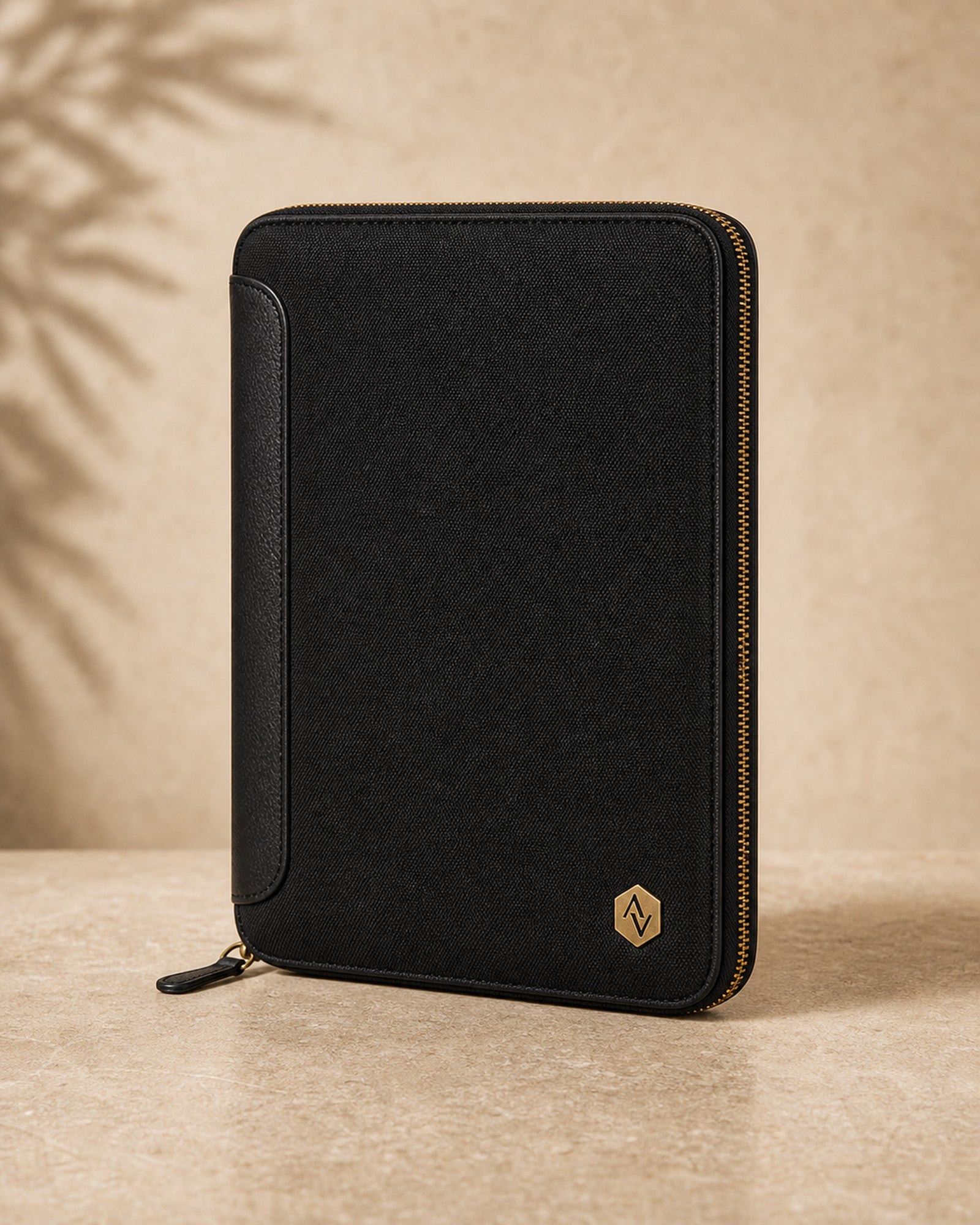 The Tech Folio shown on a warm neutral studio background.