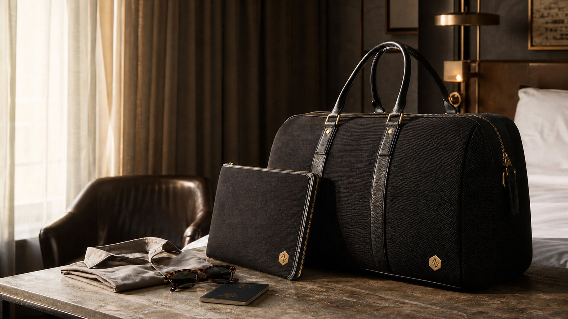 Atlas and Vale Weekender and Tech Folio in a warm boutique hotel room with soft morning light.